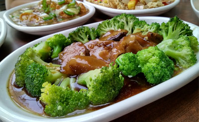 Broccoli and musrooms on plate in sauce