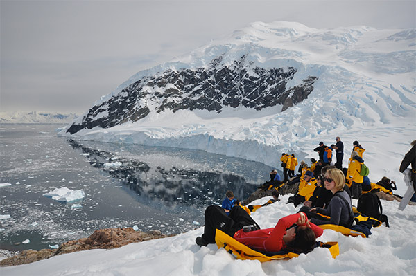 People laying on snow in Antarctica