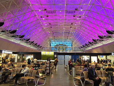 KEF interior shot showing the main waiting area, with high roof and lit with blue and purple lights