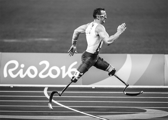 Man running at paralympic games black and white image