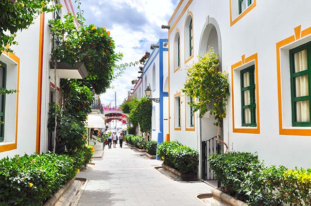 A tree lined street with white houses in Marbella
