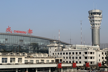 exterior shot of airport building, with 'Chengdu' sign above modern glass front