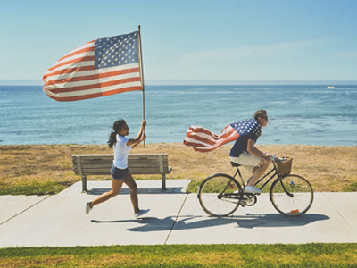Man riding bike with American flag